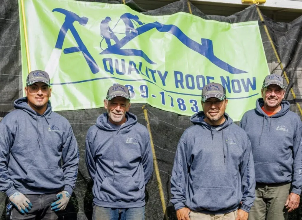 The A Quality Roof Now roofing crew together on a job site